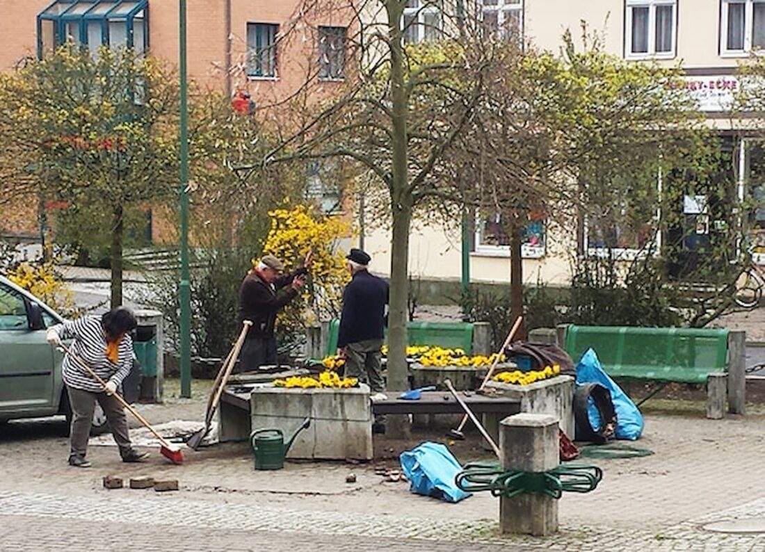 Personen beim Reinigen einer Straße.